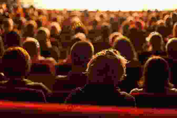 Audience Watching A Movie In A Theater Hollywood Propaganda: How TV Movies And Music Shape Our Culture