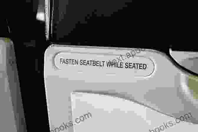 The Seat Belt Sign Is On Book Cover, Featuring A Close Up Of An Airplane Seat Belt With The Sign Illuminated The Seat Belt Sign Is On